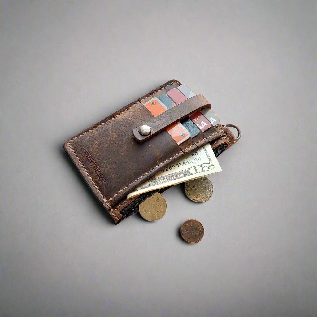 Leather keychain wallet open, showing card slots and interior space for cash or small essentials.