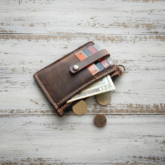 Leather keychain wallet open, showing card slots and interior space for cash or small essentials.