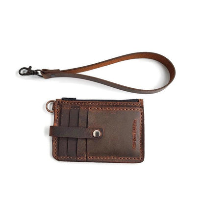 Close-up of the crazy horse color wallet with brass dee ring and swivel clip attached to the leather wallet for easy carrying.